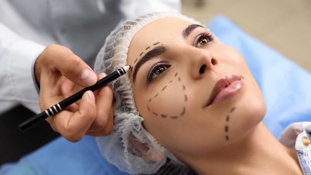 Mujer en consulta de medicina estética en Marbella marcada para tratamiento facial, representando la diferencia entre cirugía estética y medicina estética con un enfoque profesional y natural.