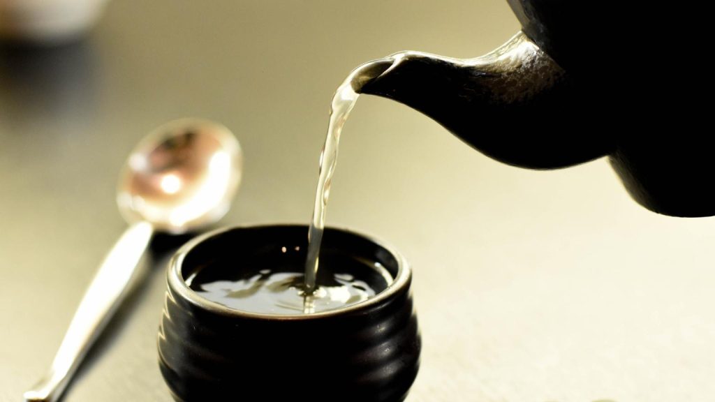 Los mejores tés e infusiones para el sistema inmunológico servidos en una taza de cerámica con tetera tradicional