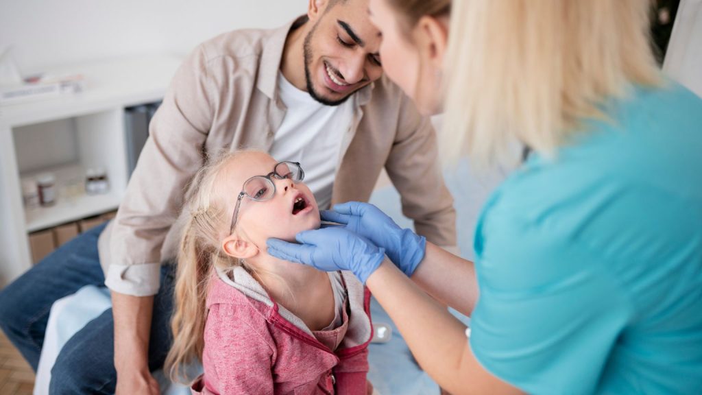 Toronto dental care clinic with diverse family smiling with dentists in a modern bright office