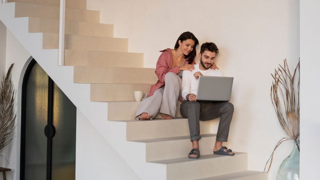 Pareja hablando con agencia inmobiliaria y evaluando zonas antes de comprar vivienda