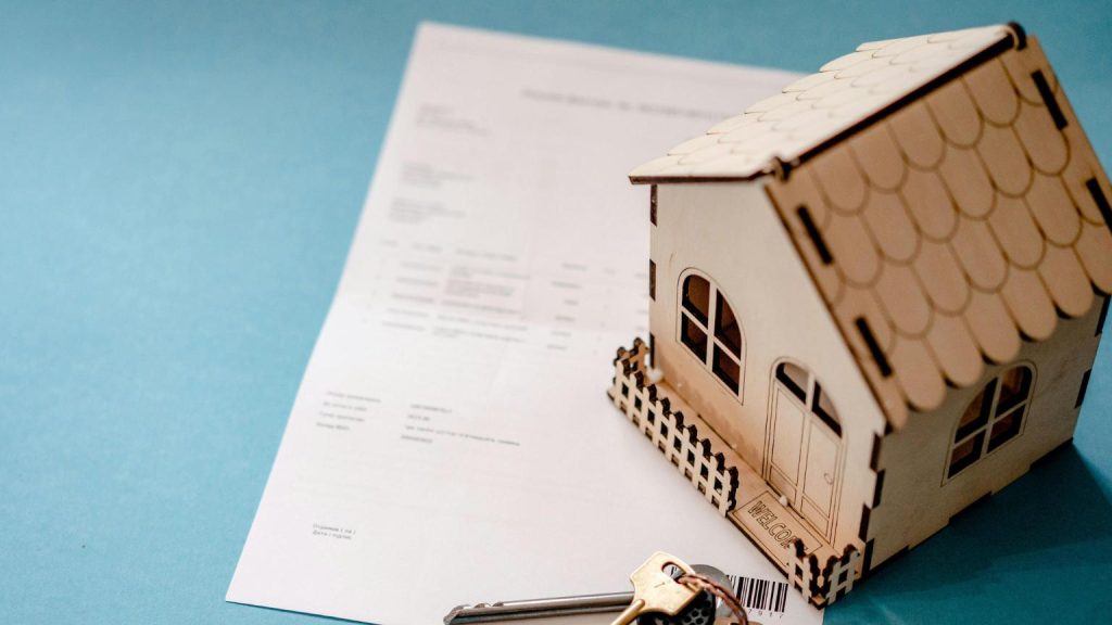Property management protecting a home investment with keys and property documents