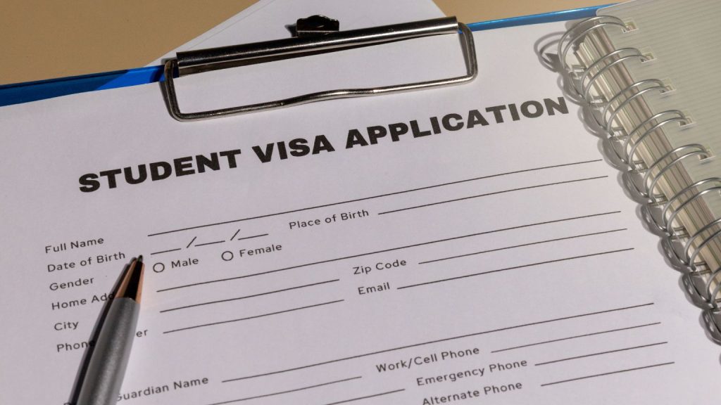 Student visa application form on a clipboard, representing legal planning and documentation for student visas for Spain.